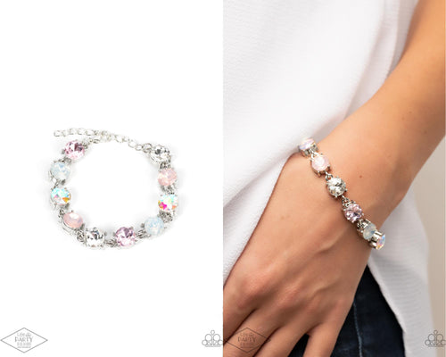 An oversized collection of icy, pink, white, and iridescent rhinestones delicately link around the wrist for a stellar shimmer. Features an adjustable clasp closure.  Sold as one individual bracelet.