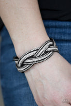 Load image into Gallery viewer, Dusted in glitter, skinny black strands braid with rhinestone encrusted strands across the wrist for a sassy look. Features an adjustable snap closure.
