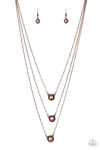 Three copper pearl drop pendants layer down the chest in a refined fashion. Features an adjustable clasp closure.