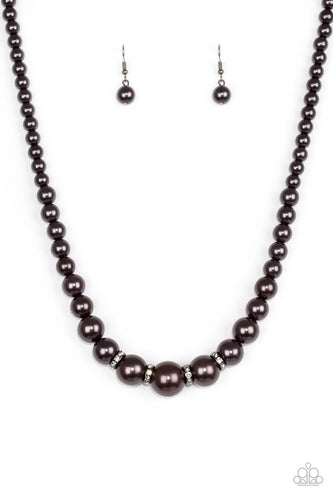 Gradually increasing in size, pearly gunmetal beads trickle below the collar for a classic look. Encrusted in dazzling white rhinestones, glittery rings are sprinkled between the pearls for a timeless finish. Features an adjustable clasp closure