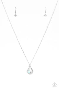 A dainty blue blossom, glittery white rhinestone, and opal rhinestones are nestled inside an ornate silver teardrop, creating a whimsical pendant below the collar. Features an adjustable clasp closure.