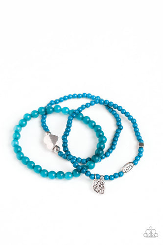An array of glassy and polished blue beads are threaded along stretchy bands. Infused with silver accents, a collection of silver heart charms and a bead spelling out the word, 