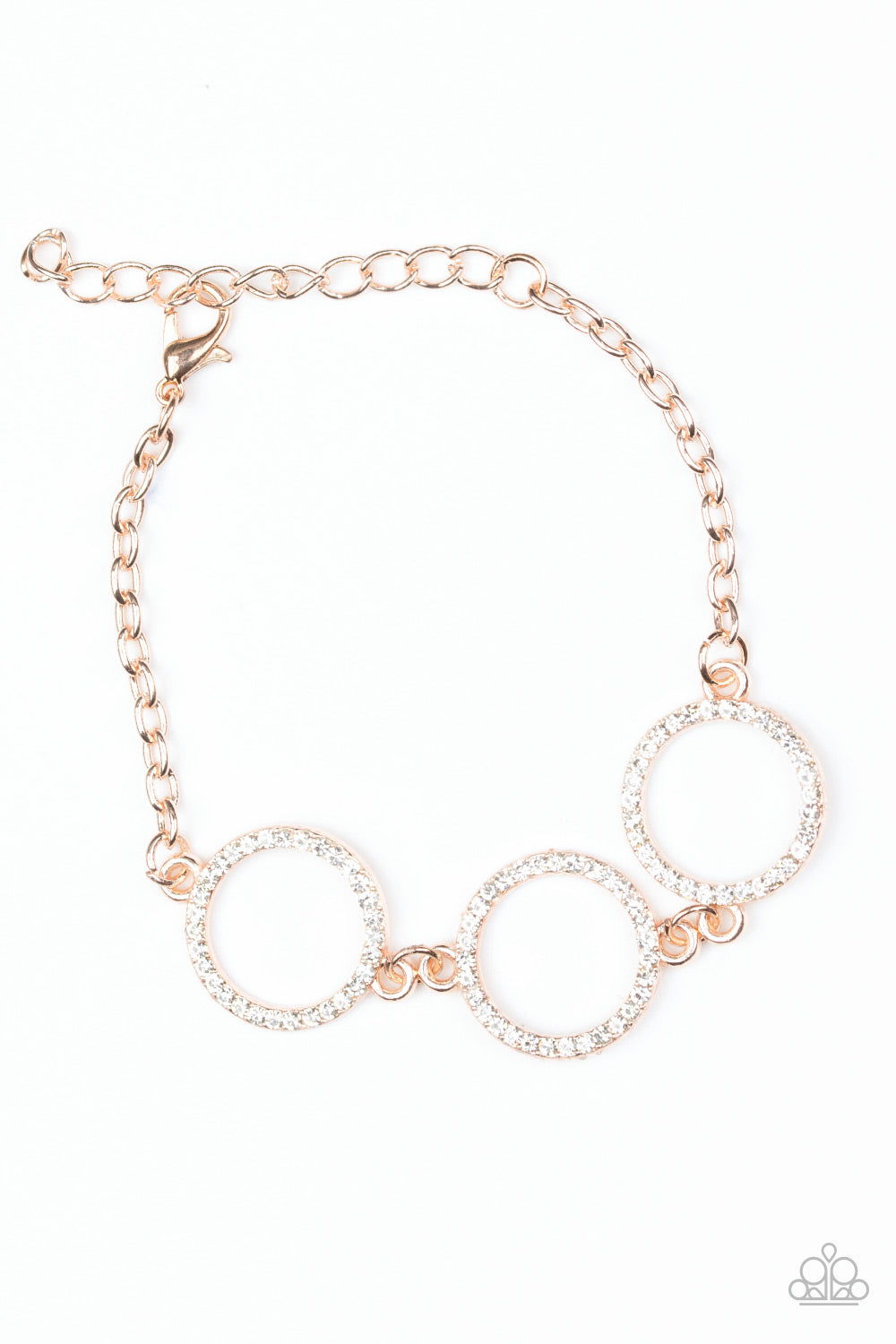 Encrusted in glassy white rhinestones, three glittery rose gold rings link across the wrist for a glamorous look. Features an adjustable clasp closure.
