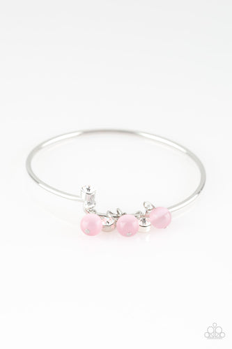 Glassy pink beads and glittery white rhinestones slide along a dainty silver wire infused with a rhinestone encrusted fitting, creating a versatile adjustable like bangle. Features a hinged closure.