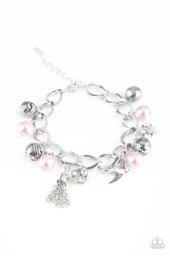Pink pearls, ornate silver beads, and white rhinestone encrusted accents swing from a dramatic silver chain. A shimmery silver bird charm and silver tassel are added to the display, creating a whimsical fringe around the wrist. Features an adjustable clasp closure.