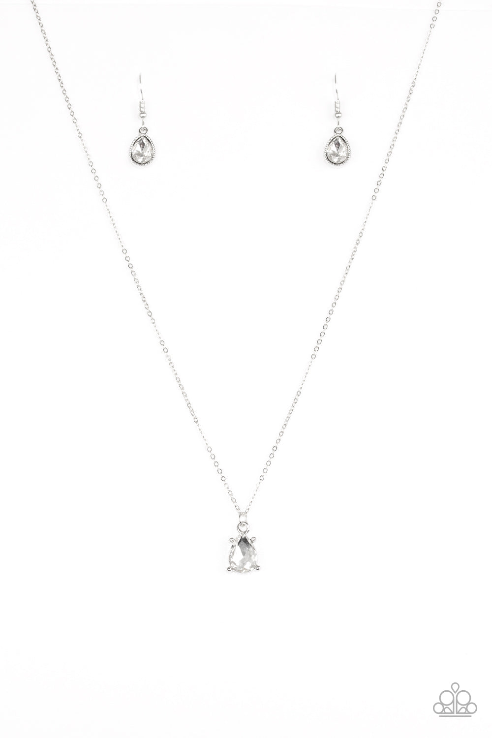 Featuring a regal teardrop cut, a glittery white gem swings from the bottom of a dainty silver chain, creating a timeless pendant below the collar. Features an adjustable clasp closure