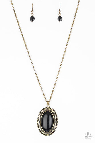 Brushed in a faux rock polish, a shiny black bead is pressed into an ornate brass frame for a seasonal look. Features an adjustable clasp closure.