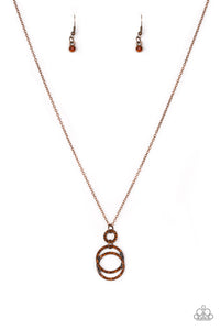 Encrusted in radiant rhinestones, three copper hoops interlock at the bottom of an elongated copper chain for an elegant look. Features an adjustable clasp closure.