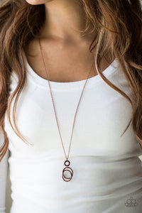 Encrusted in radiant rhinestones, three copper hoops interlock at the bottom of an elongated copper chain for an elegant look. Features an adjustable clasp closure.