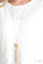 Load image into Gallery viewer, A delicately hammered gold disc is stamped in the inspirational word, &quot;faith&quot; and suspended from a double-hooped pendant at the bottom of an elongated gold satellite chain. A gold tassel swings from the bottom of the shimmery palette for a whimsical finish. Features an adjustable clasp closure.
