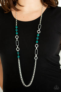 A collection of glassy and polished green beads give way to layers of mismatched silver chain for a whimsical look. Features an adjustable clasp closure. 