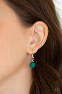 A collection of glassy and polished green beads give way to layers of mismatched silver chain for a whimsical look. Features an adjustable clasp closure. 