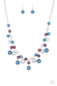 Varying in size, bubbly blue, purple, and silver pearls swing from the bottom of a classic strand of pearls, creating a refined fringe below the collar. Features an adjustable clasp closure.