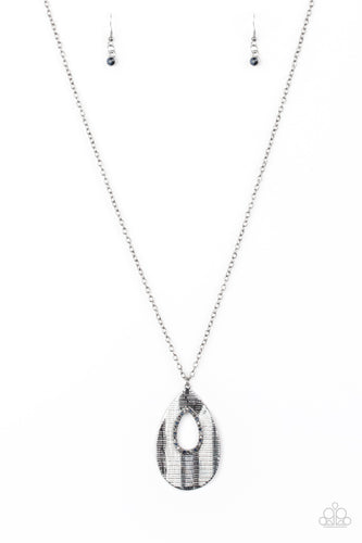 Embossed in a linear geometric pattern, a warped gunmetal teardrop swings from the bottom of a lengthened gunmetal chain. Glittery blue, hematite, and smoky rhinestones are encrusted around the center of the teardrop pendant for a sparkling finish. Features an adjustable clasp closure.