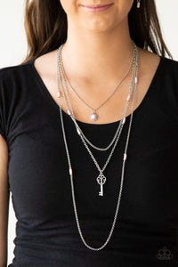 Featuring flirty pink and dainty silver accents, a pink beaded pendant gives way to a shimmery silver key for a whimsically layered look. Features an adjustable clasp closure.