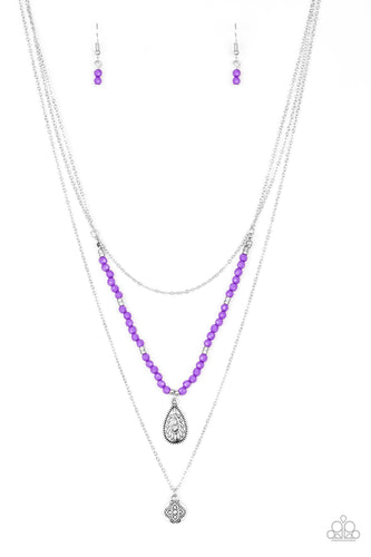 Infused with vivacious purple beading and an ornate silver teardrop pendant, a colorfully beaded strand gives way to a plain silver chain and a dainty silver chain featuring an antiqued pendant for a whimsically layered look. Features an adjustable clasp closure.