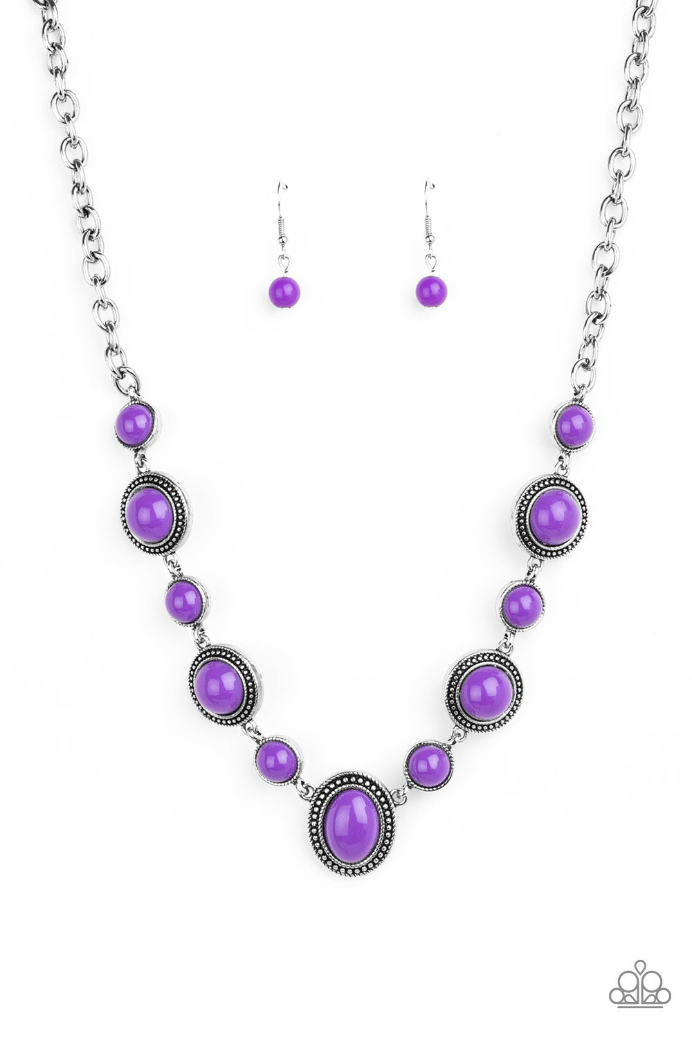 Featuring smooth and studded silver frames, vivacious purple beads link below the collar in a seasonal fashion. Features an adjustable clasp closure.