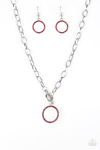 Encrusted in fiery red rhinestones, a bubbly silver pendant swings below the collar for a colorfully casual look. Features a toggle closure.