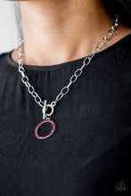 Load image into Gallery viewer, Encrusted in fiery red rhinestones, a bubbly silver pendant swings below the collar for a colorfully casual look. Features a toggle closure.
