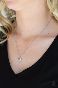 Encrusted in glittery white rhinestones, a dainty silver pendant swings below the collar for a glamorous look. Features an adjustable clasp closure