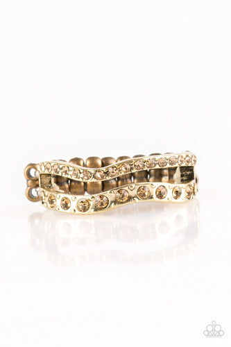 Varying in size, golden topaz rhinestones are encrusted along waving brass bands for a refined look. Features a dainty stretchy band for a flexible fit.