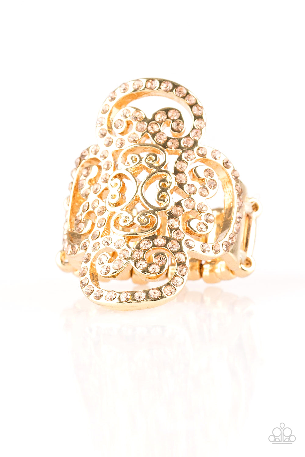 Dainty peach rhinestones are encrusted along a glistening gold frame radiating with regal filigree for a refined look. Features a stretchy band for a flexible fit.