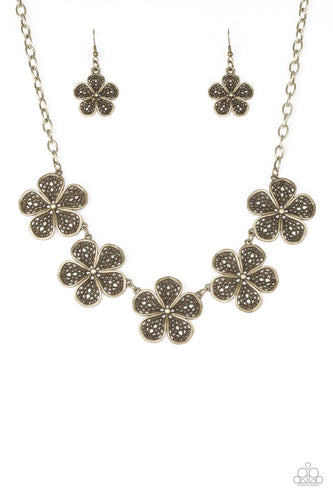 Featuring lace-like petals, glistening brass daisies link below the collar for a seasonal look. Features an adjustable clasp closure.