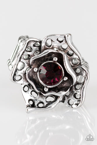 Featuring airy cut-out textures, antiqued silver petals gather around a glowing purple rhinestone center for a whimsical look. Features a stretchy band for a flexible fit