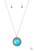 Load image into Gallery viewer, A refreshing turquoise stone is pressed into the center of a shimmery silver frame radiating with sunburst details. The earthy frame swings from the bottom of a lengthened silver chain for a seasonal finish. Features an adjustable clasp closure.
