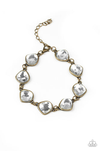 Featuring antiqued brass frames, imperfect glassy white gems link around the wrist for a glamorous vintage inspired look. Features an adjustable clasp closure.