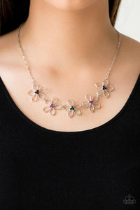Dotted with radiant multicolored rhinestone centers, airy silver flowers link below the collar for a seasonal look. Features an adjustable clasp closure.