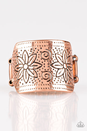 Stamped in floral detail, a thick copper band arcs across the finger for a seasonal look. Features a stretchy band for a flexible fit. 