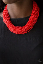 Load image into Gallery viewer, Infused with two bold silver fittings, countless strands of fiery red seed beads drape below the collar for a seasonal look. Features an adjustable clasp closure.  Sold as one individual necklace. Includes one pair of matching earrings.
