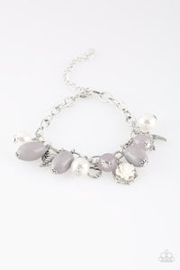 Gorgeous pearls, luminescent gray beading, and a collection of shiny silver charms, including a bird and a feather, dance around the wrist in a whimsical fashion. Features an adjustable clasp closure.