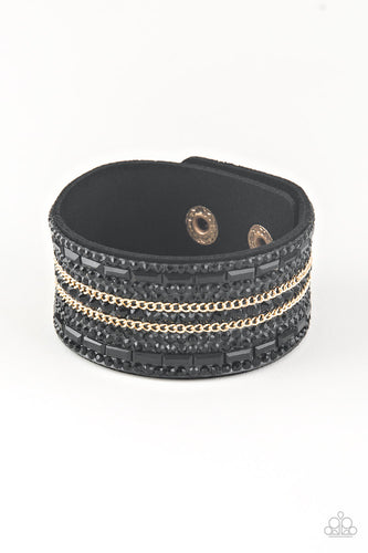 Featuring classic round and edgy emerald style cuts, glittery black rhinestones and glistening gold chains are encrusted along bands of black suede for a sassy look. Features an adjustable snap closure