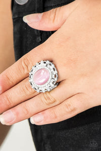 Encrusted in dainty white rhinestones, a frilly silver frame spins around a glowing pink moonstone center for a regal look. Features a stretchy band for a flexible fit.