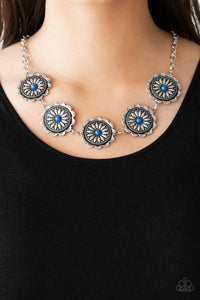 Infused with bright blue beaded centers, ornate floral stamped frames link below the collar for a colorfully, seasonal look. Features an adjustable clasp closure.