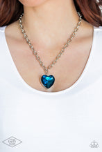 Load image into Gallery viewer, Set atop a sleek silver fitting, a glittery blue heart-shaped gem swings from the bottom of a classic silver chain below the collar for a whimsical look. Features an adjustable clasp closure.
