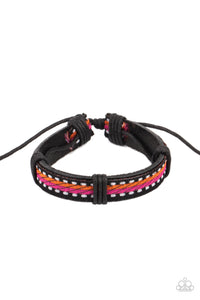 Featuring orange, pink, and white thread, a decorative textile is knotted in place across the front of a dainty brown leather band for an adventurous look. Features an adjustable sliding knot closure.