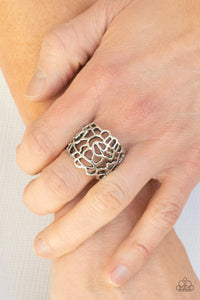 Frilly silver filigree connects into an asymmetrical stenciled frame across the finger, creating an edgy centerpiece. Features a stretchy band for a flexible fit.  Sold as one individual ring.