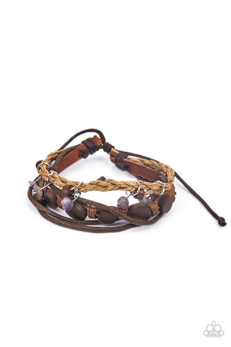 Assorted strands of cording and leather, featuring flat wooden beads and small purple polished stones dangling from silver fittings, layer across the wrist for an earthy handcrafted style. Features an adjustable sliding knot closure.  Sold as one individual bracelet.