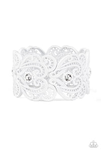 Painted in a refreshing white finish, lacy metallic frames are threaded along stretchy bands around the wrist. Glassy white rhinestones dot each frame, adding elegant shimmer to the whimsical piece.