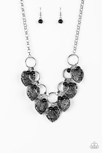 Infused with shiny black beads, vintage locket-like heart frames swing from the bottoms of bold silver hoops, creating a flirtatious fringe below the collar. Features an adjustable clasp closure.