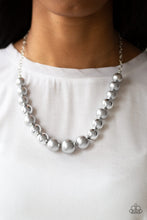 Load image into Gallery viewer, A collection of oversized silver and pearly silver beads drape across the chest for a refined look. Features an adjustable clasp closure.
