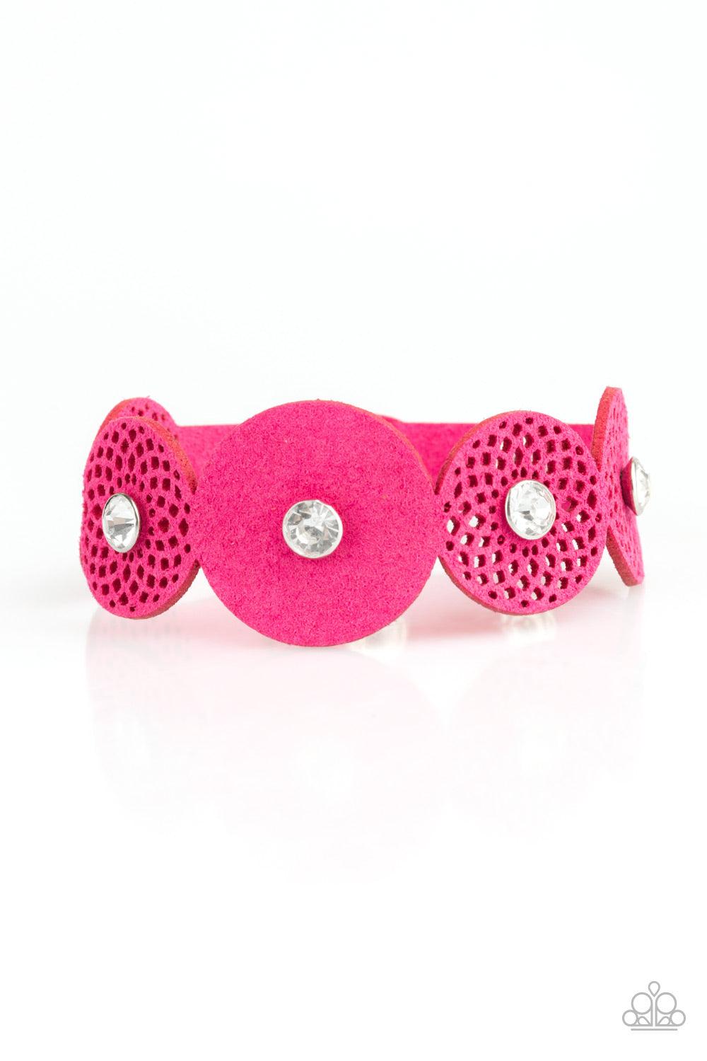Dotted with white rhinestone centers, round pink suede frames join across the wrist for a whimsical look. Features an adjustable snap closure.