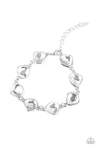 Featuring shimmery silver frames, imperfect white gems link around the wrist for a glamorous vintage inspired look. Features an adjustable clasp closure.