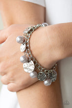 Load image into Gallery viewer, A collection of hammered silver discs and pearly silver beads swing from a thick silver chain, creating an elegant fringe around the wrist. Features an adjustable clasp closure. 
