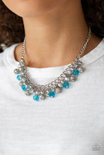 Load image into Gallery viewer, A collection of metallic net covered beads, shiny silver beads, and glittery blue and metallic flecked crystal-like beads swing from the bottom of interlocking silver chains, creating a refined fringe below the collar. Features an adjustable clasp closure.

