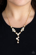 Load image into Gallery viewer, Encased in sleek gold frames, a collection of glittery white rhinestones coalesce into dazzling frames below the collar. Matching rhinestones trickle from the center, creating a glamorous extended pendant. Features an adjustable clasp closure.
