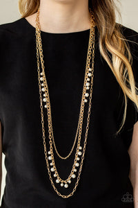 Three mismatched gold chains layer down the chest. Dainty white pearls cascade down one gold chain, adding a flirty twist to the timeless pearl palette. Features an adjustable clasp closure